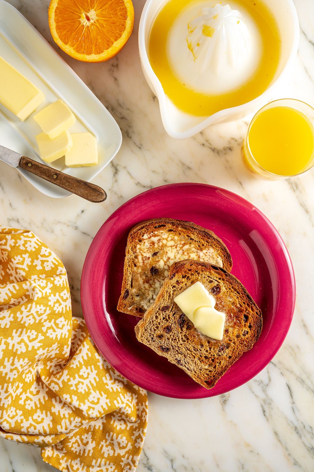 Buttered toast on a red plate